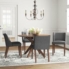 a dining room table with chairs and a chandelier