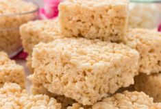 rice krispy treats stacked on top of each other in front of pink and white flowers