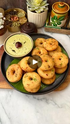 an assortment of food on a plate with dipping sauce