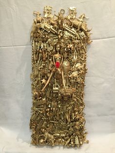 a gold sculpture with many different types of objects on it's face and body