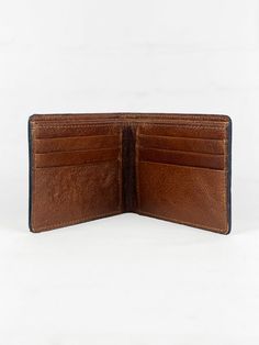 The Men's Bi-Fold Western Wallet with Tooled Accent is a sophisticated blend of functionality and Western charm. Crafted from high-quality leather, this wallet is both durable and stylish, perfect for the modern cowboy with a taste for traditional Western style. The exterior of the wallet features a meticulously tooled Western flower accent, adding an element of artistic craftsmanship that sets this wallet apart. Its bi-fold design opens to a well-organized interior, complete with multiple card slots for credit cards and business cards, alongside a divided cash pocket that allows for easy segregation of bills and receipts. Whether it's for your own daily use or as a special gift, this wallet is designed to impress with its elegance and practicality. Closure Type Bi-fold Size 4.5"w x 3.5"h Classic Bifold Wallet With Leather Patch, Brown Leather Wallet With Leather Patch, Classic Leather Trifold Wallet With Coin Pocket, Classic Leather Trifold Wallet With Coin Pocket For Everyday, Distressed Brown Bifold Wallet For Everyday Use, Brown Bifold Wallet With Leather Patch, Rugged Brown Bifold Wallet, Brown Bifold Wallet With Rfid Blocking, Brown Wallet With Coin Pocket For Everyday Carry