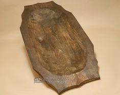 an old wooden cutting board sitting on top of a table