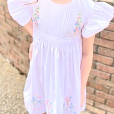 Free Shipping when you spend $75 or more. Use code PSFREESHIP at checkout. This listing is for the dress only, bows are listed separately.  Sizing These dresses run true to size or a little big. Size H(In) 3M - 14 6M - 15 9M - 16 12M - 17 1/4 18M - 19 2T - 21 3T - 22 1/2 4T - 24 5T - 25 1/4 6 - 26 1/4 7 - 27 8 - 28 Sign up for our mailing list for 10% off your first order from our website! http://eepurl.com/cP9j4j   Please note these items are ready to ship, we cannot take custom orders nor make alterations. Thanks!   Clothing Care Instructions Most items can be washed safely in cold water on delicate cycle and hung to dry. If the item that you are ordering has red or another bright color in it next to a  white or other light color fabric please use a Shout color catcher for the first few White Flutter Sleeve Dress With Smocked Bodice, White Dress With Smocked Bodice And Flutter Sleeves, Spring Embroidered Smocked Dress With Short Sleeves, White Smock Dress With Flutter Sleeves, Spring Smock Dress For Dress-up, Spring Embroidered Smocked Dress For Daywear, Embroidered Smocked Dress For Spring Daywear, Short Sleeve Dress With Smocked Bodice For Wedding, Wedding Dress With Smocked Bodice And Short Sleeves