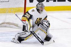 a hockey goalie is waiting for the puck