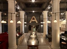 the inside of a building with columns and lights