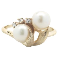 Material: 10K yellow gold Pearl: 6.50mm akoya Diamond: 3 round brilliant cut = .05cttw Color: H Clarity: SI1 Ring Size: 8.5 (please allow two additional shipping days for sizing requests) Dimensions: ring measures 13.30mm wide Weight: 3.59 grams Bypass Ring, Akoya Pearls, Pearl Diamond, Gold Pearl, Pearl Ring, Round Brilliant Cut, Round Brilliant, Fashion Rings, Jewelry Rings