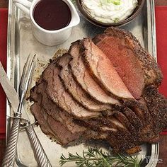 a tray with meat and sauces on it