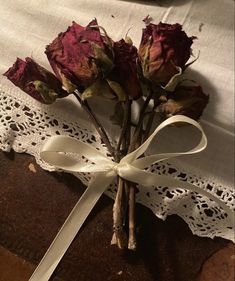 a bouquet of roses tied to a piece of cloth