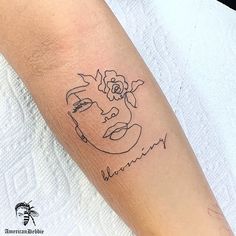 a woman with a flower tattoo on her arm