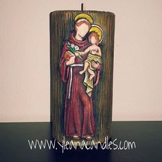 a candle with an image of the virgin mary holding a baby jesus