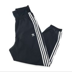 Step Into Comfort And Style With These Adidas Black & White Athletic Track Pants. Perfect For Casual Outings Or A Brisk Walk In The Park, These High-Rise, Relaxed Fit Pants Are Your New Go-To For Any Season. With Their Breathable Fabric And Iconic Adidas Logo Accent, You'll Be Strutting In Style While Enjoying The Perfect Blend Of Fashion And Function. Features: - Made In Vietnam - Suitable For Winter, Summer, And Spring - Ideal For Casual And Travel Occasions - Straight Leg Style - Logo Accent Adidas Sporty Summer Pants, Adidas Black Pants For Spring, Black Joggers With Three Stripes, Jogging Pants Black, Brisk Walk, Tapered Sweatpants, Black Tracksuit, Relaxed Fit Pants, White Windbreaker