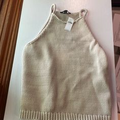 Never Worn. Tan Sweater Tank. Trendy Knitted Beige Tops, Trendy Beige Knitted Tops, Cozy Beige Tops For Spring, Casual Knitted Crop Top For Winter, Cozy Beige Tops For Day Out, Cozy Beige Top For Day Out, Beige Casual Sweater For Vacation, Winter Vacation Knitted Tops, Chic Cotton Beach Sweater