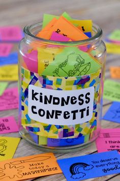 a glass jar filled with colorful sticky notes