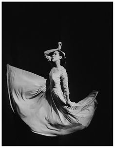 a black and white photo of a woman in a dress with a quote on it