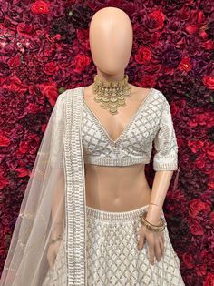 Be your own fashionista with this ivory lehenga. The lehenga is encrusted with very desirable jardozi embroidery and sequins work which is eye catching! Key Features: Color: Ivory Lehenga Fabric: Luxurious silk or similar Embellishments: Intricate silver or gold embroidery or embellishments Silhouette: Flowing and graceful Dupatta: Sheer dupatta with intricate border White Lehenga With Intricate Embroidery, Fitted Embellished Cream Lehenga, Festival White Lehenga With Embroidered Border, Embellished Fitted Cream Lehenga, White Lehenga With Embroidered Border, Party Mix, Net Dupatta, Gold Embroidery, Thread Work