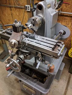 a machine that is sitting in the middle of some kind of workbench with tools on it