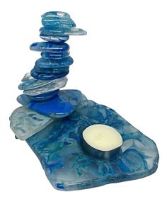 a candle is sitting on top of some rocks