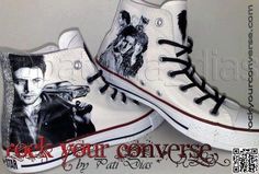 a pair of white sneakers with the image of johnny depporard painted on them