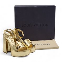 - Gold. - Metallic Ayers Leather (Snakeskin). - Lambskin Lining. - Leather Outsole. - 12 Cm / 4.7-Inch Heel With 9.5 Cm / 3.7-Inch Comfort. - Lv Accessory. - Made In Italy. Size: 35 Condition: Brand New With Box. Minor Scuffs As Shown In The Pictures. Luxury Patent Leather Sandals, Luxury Patent Leather Sandals With Block Heel, Luxury Gold Platform Sandals, Luxury Gold Platform Heels, Luxury Leather Heels, Luxury Heels With Heel Strap, Louis Vuitton Pumps, Louis Vuitton Heels, 7 Inch Heels