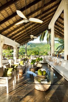 an outdoor living area with couches and tables