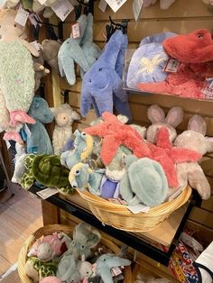 many stuffed animals are on display in a store