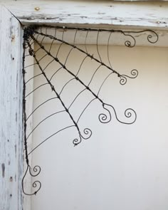 a spider web hanging from the side of a door