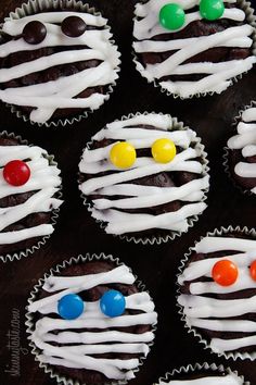 cupcakes decorated with white icing and colorful candies are displayed on an instagram page