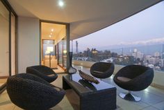 a living room with two chairs and a coffee table in front of a large window