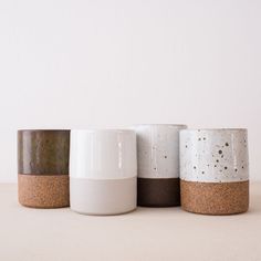 three different types of cups sitting on top of a white table next to each other