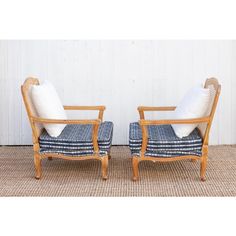 a pair of chairs sitting next to each other on top of a carpeted floor