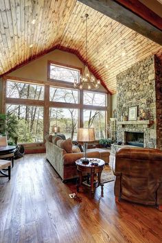 a living room filled with furniture and a fire place next to a large glass window