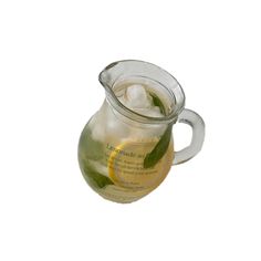 a glass pitcher filled with lemonade and ice