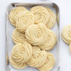 some white frosted cookies in a metal pan