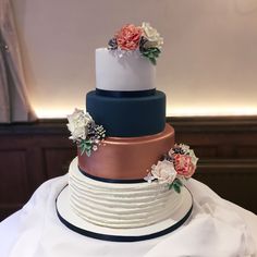 three tiered wedding cake with flowers on top