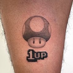 a close up of a person's leg with a mushroom tattoo on it