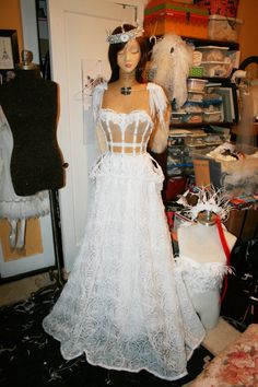 a mannequin is dressed up in a white dress