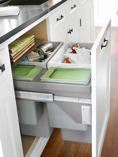 an open drawer in a kitchen filled with dishes