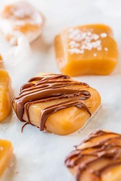 several pieces of caramel with chocolate drizzled on them