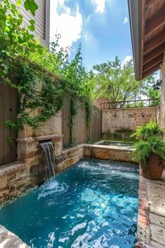 an outdoor pool with a waterfall in the middle