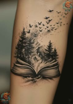 an open book with birds flying out of it and trees on the pages tattoo design