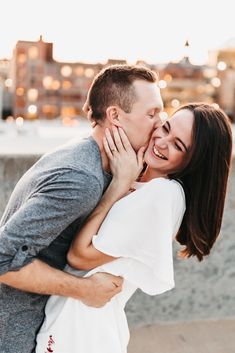 a man and woman are hugging each other