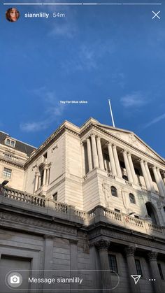 an old building with columns and pillars against a blue sky, on the phone screen