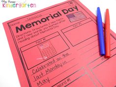 two red and blue pens sitting on top of a pink piece of paper with the words memorial day written in it