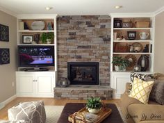 a living room filled with furniture and a flat screen tv mounted on a wall above a fire place