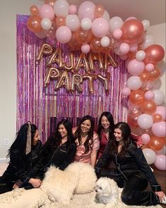 the girls are posing with their dog in front of balloons and streamers that read'pajama party '