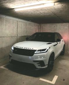 a white range rover parked in a parking garage