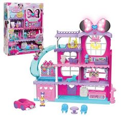 a pink and blue doll house with lots of furniture