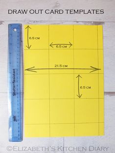 a ruler is next to a piece of yellow paper with the measurements for each card