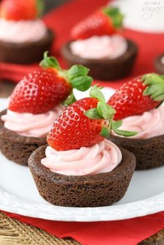 chocolate cupcakes with strawberry frosting and fresh strawberries on top, ready to be eaten