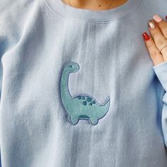 Dino Embroidered Crewneck Adorable baby dino embroidered by me! The dinosaur can be made any color! If you want a specific color dinosaur just message me and I can make it for you :) Cute Embroidery Dinosaur, Dino Embroidery, Dinosaur Embroidery, Comfy Sweatshirts, Baby Sweats, Dinosaur Sweater, Navy Blue Hoodie